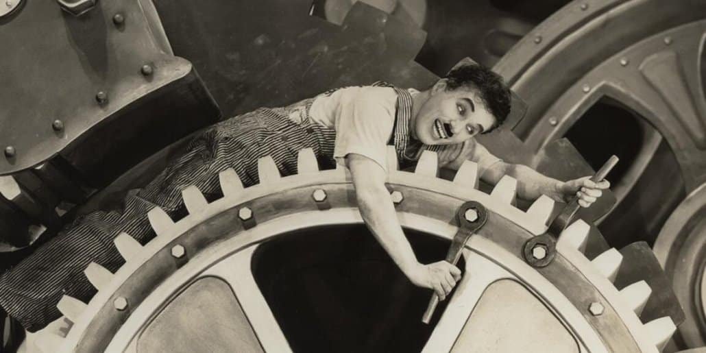 Quand Chaplin s’invite dans les fusions-acquisitions : une danse moderne entre rouages et rêves, succession et transmission d'entreprise Suisse