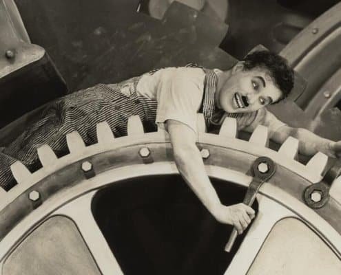 Quand Chaplin s’invite dans les fusions-acquisitions : une danse moderne entre rouages et rêves, succession et transmission d'entreprise Suisse